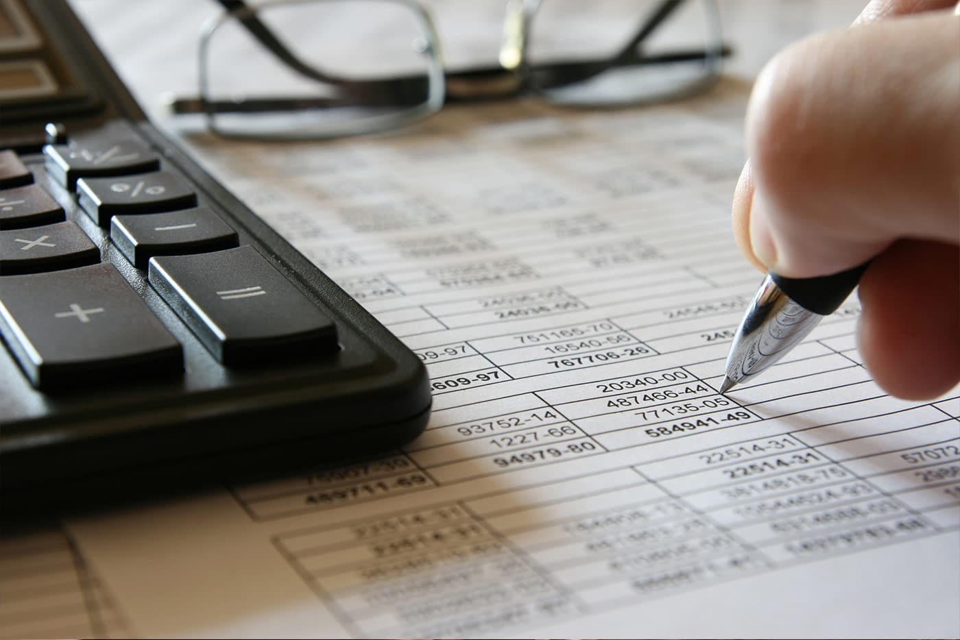 Business owner preparing finances to file Schedule K-1 tax form.
