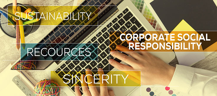 Hands typing on a keyboard and a business article sitting on a desk with the words "Ethics" and "Corporate Social Responsibility" in an overlay.