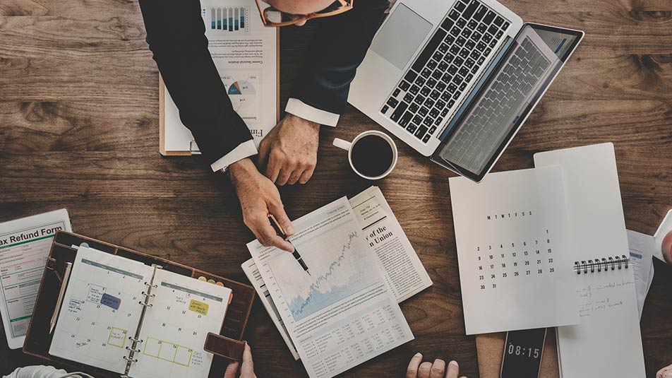 Aerial view of a business owner creating a marketing calendar.