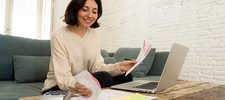 A woman completes paperwork. We’re taking you through the numerous sections you need to complete for SBA Form 413.
