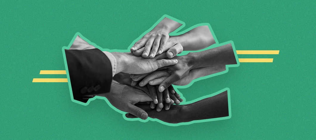 Several hands placed one on top of the other