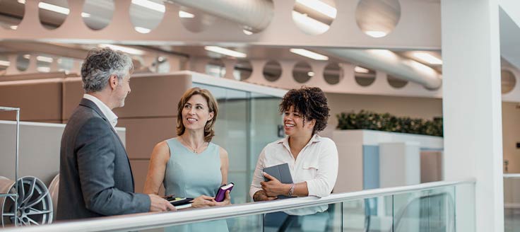 A successful entrepreneur effectively communicating with two employees.