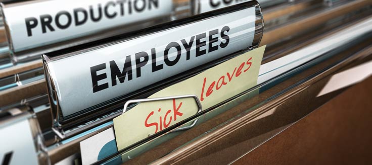 A file folder with a "sick leaves" note pinned to it sits among other personnel files.
