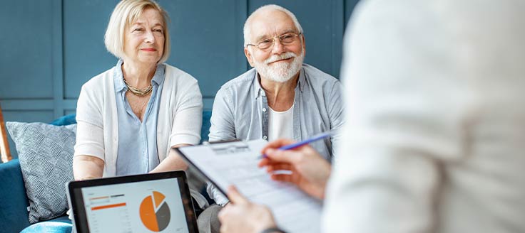Two older individuals speak with a consultant. In business succession planning, it can help to hire an outside consultant.