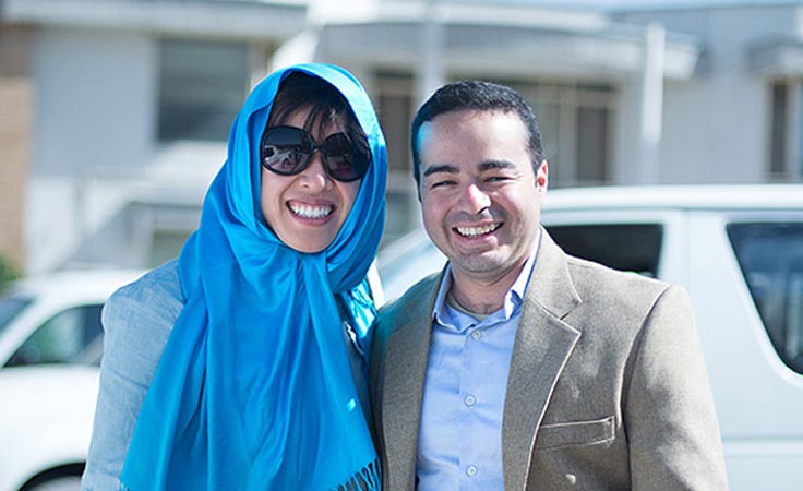 A couple smiles for the camera, perhaps after being awarded a specialized business grant.