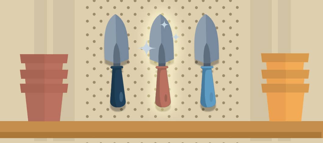 Three hand shovels hang on a store rack, their handles different colors. The shovel in the middle sparkles and glows.