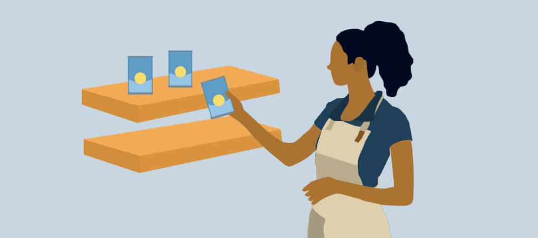 A restaurant employee stocks a shelf with products.