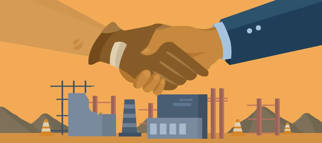 Two hands, one from a construction contractor wearing work gloves, the other from a business professional, shake. A factory is under construction in the background.