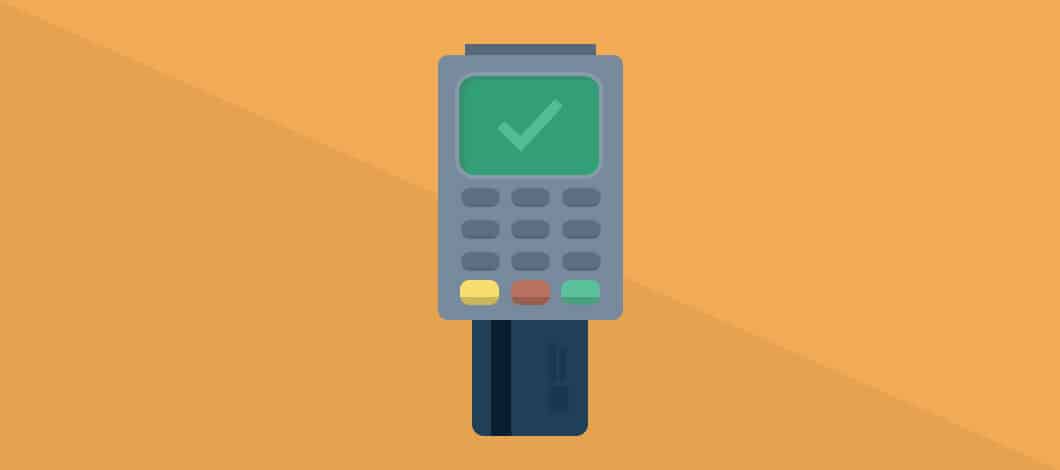 A credit card has been inserted into a chip reader to process a payment.