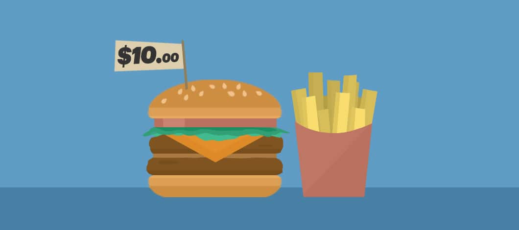 There is a cheeseburger with lettuce and tomato and a side of fries. A little sign sticks out of the bun that reads “.00.”