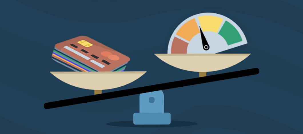 A stack of credit cards sits on one side of a scale and a credit score meter (with the needle in the middle) sits on the other side.