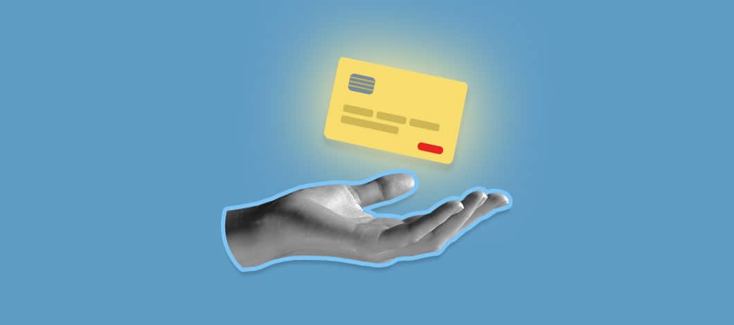 A glowing credit card hovers about an open palm of a hand.