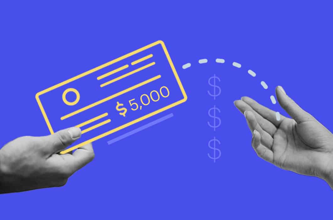 One hand extends a check for ,000 to another hand.