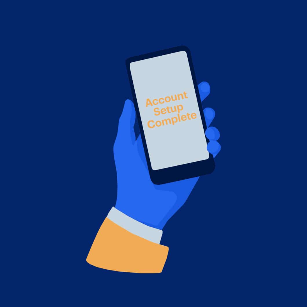 A hand holds a cellphone. The screen reads “Account Setup Complete.”